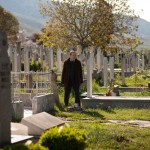 Man standing in a Mostar cemetery