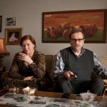 Couple seated on a sofa in a living room