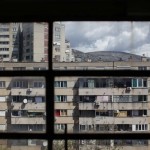 View through a window of Mostar apartment blocks and mountains